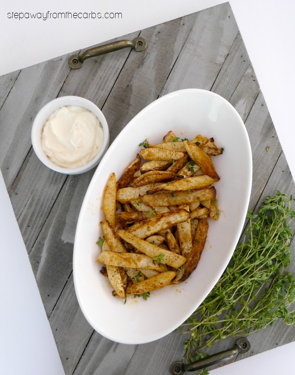 Seasoned turnip fries in a white oval dish with mayo and fresh thyme