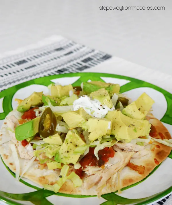Low Carb Chicken Tostadas - a crispy tortilla loaded with chicken, cheese, salsa, avocado, and more!
