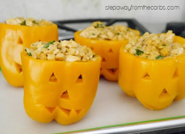 Low Carb Halloween Peppers - stuffed with cauliflower rice, chicken, and cheese!