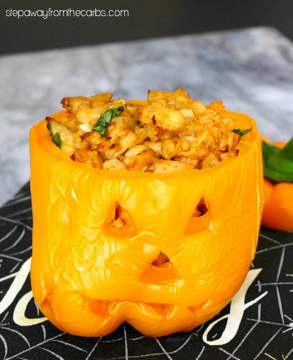 Low Carb Halloween Peppers - stuffed with cauliflower rice, chicken, and cheese!