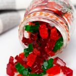 Keto low carb gummy bears spilling out of a jar
