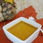 Low carb pumpkin pie creme brulee in a white square ramekin on an autumn leaf placemat