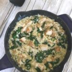 Creamy chicken, spinach and cauliflower rice casserole in a cast iron skillet