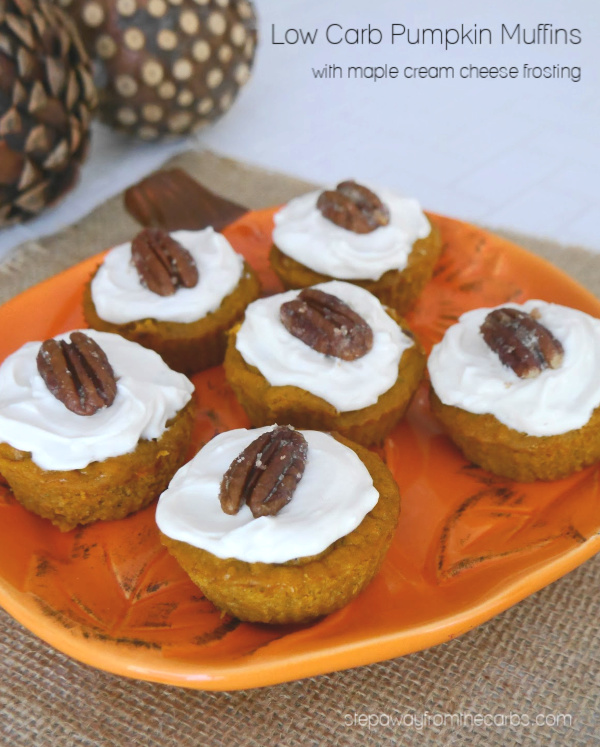 Low Carb Pumpkin Muffins topped with cream cheese frosting and a pecan