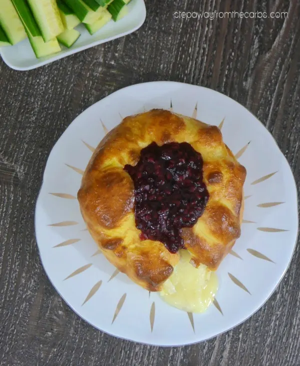 Low Carb Brie En Croute - an indulgent appetizer! Brie wrapped in Fathead dough and served with a blackberry sauce. 