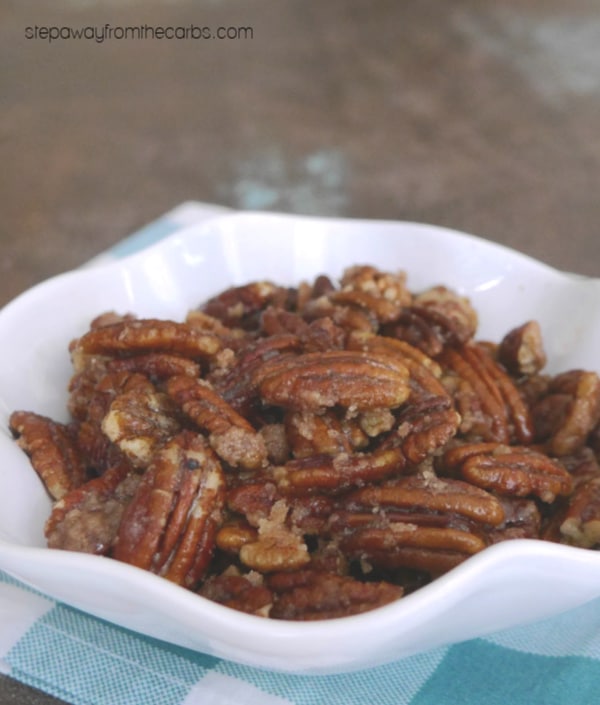 Sugar free caramelized pecans in a white scalloped bowl