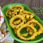 Low carb maple delicata squash rings roasted with thyme on a green platter