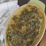 Overhead view of golden baked beef florentine casserole with spinach