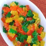Sugar free sour gummy bears coated in citric acid in a white serving dish
