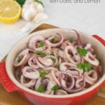 Pan fried calamari with garlic and lemon in a red tapas dish