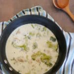 Keto Alfredo soup with chicken and broccoli in a black saucepan