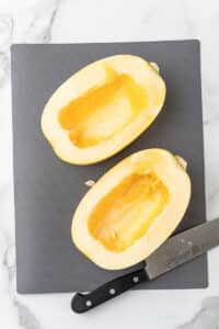 Spaghetti squash halves with the seeds scooped out