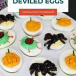 Halloween Spider Deviled Eggs Pinterest pin with black olive spiders on deviled eggs