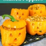 Halloween stuffed peppers pin: four jack-o'-lantern orange bell peppers on a spiderweb napkin