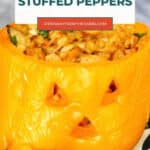 Halloween stuffed peppers pin: close-up of a carved orange bell pepper filled with chicken and cheese
