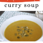Keto Coconut Curry Soup Pinterest graphic with a bowl of creamy curry soup