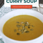Keto Coconut Curry Soup pin with a white bowl of golden cauliflower soup