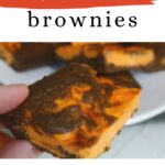 Keto Halloween Brownies Pinterest graphic with a hand holding a swirled brownie
