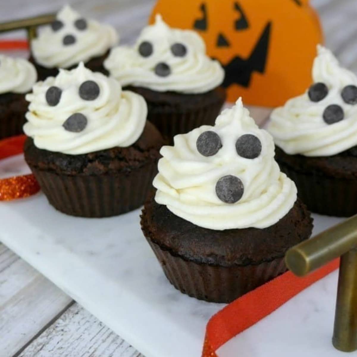 Low carb ghost cupcakes with swirled cream cheese frosting and chocolate chip faces