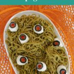 Low Carb Halloween Spaghetti pin showing green pesto noodles topped with spooky eyeballs