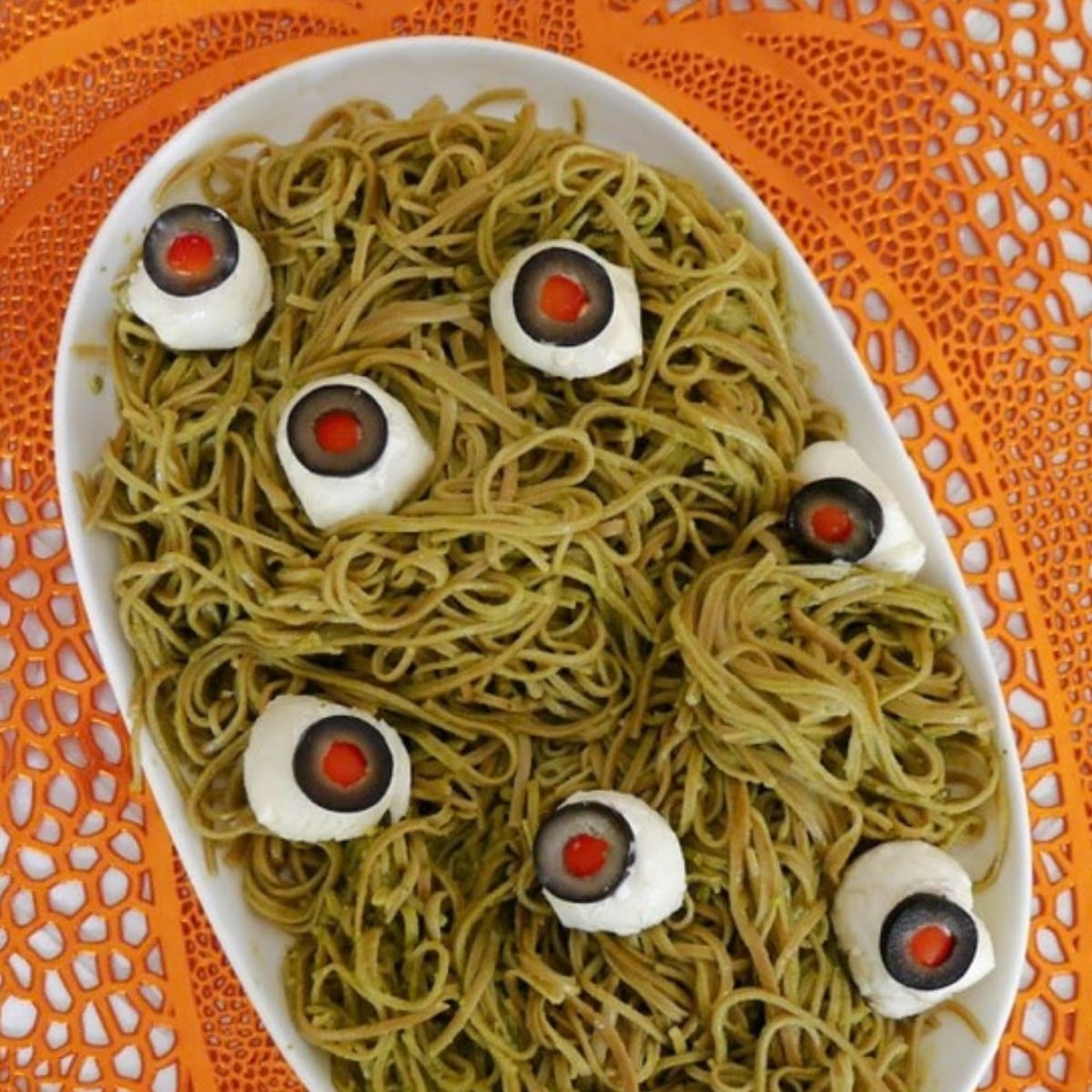 Low carb Halloween spaghetti with mozzarella and olive eyeballs on a white platter