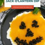 Low carb jack o'lantern dip Pinterest graphic with a cheddar pumpkin face and black olive features