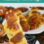Low Carb Mummy Hot Dogs Pinterest image with a hand holding a mummy dog
