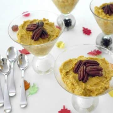 Low carb pumpkin mousse topped with caramelized pecans in glass dessert cups