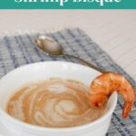 Low Carb Shrimp Bisque pin with a bowl of bisque garnished with a whole shrimp