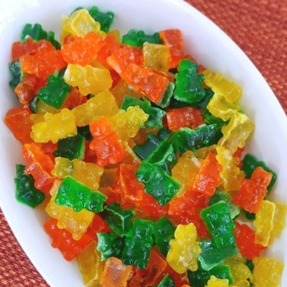 Low carb sour gummy bears in lemon, lime and orange flavors in a white serving dish