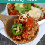 Low carb turkey chili Pinterest graphic showing a wooden spoonful of chili with jalapeno