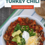Low carb turkey chili Pinterest graphic with an overhead bowl of chili