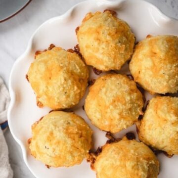 Keto crispy cheese balls on a white scalloped plate