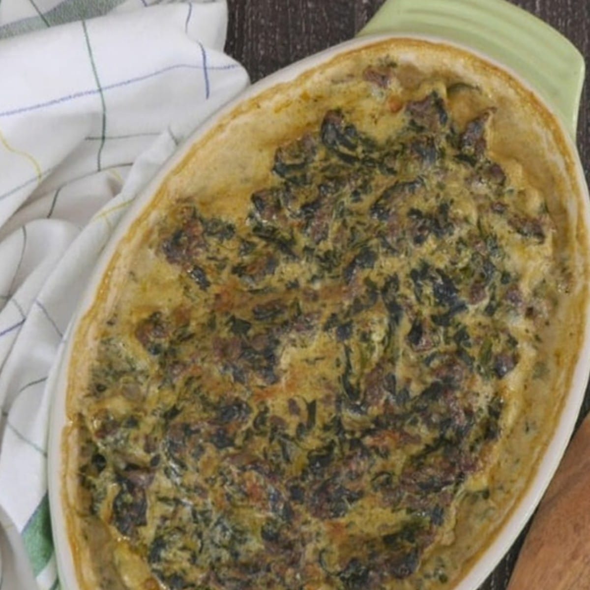Low carb beef florentine casserole with spinach and cream cheese baked in an oval dish
