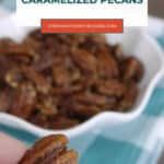 Hand holding a low carb caramelized pecan over a bowl, Pinterest graphic