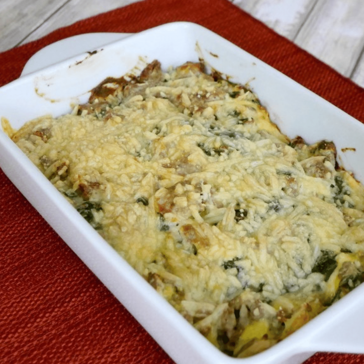 Low carb turkey casserole with cheese and spinach baked in a white dish